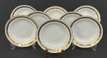 Barão do Rio Branco. Oito pratos fundos em porcelana esmaltada sobre fundo branco, decoração com faixas em ouro ornamentadas por flores e folhagens. Manufatura no verso. Pequenos desgastes no ouro compatíveis com o tempo. Craquelado. 4 x 23 cm. 