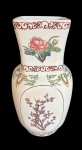 Imponente vaso em cerâmica esmaltada, decorado com delicadas cenas florais e arabescos em policromia. Peça de grande presença decorativa. Medidas: 31 x 15,5 x 15,5 cm.