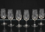Conjunto de taças  para licor em cristal translúcido; bojo ovóide alongado, haste cilíndrica e pé circular, talhado com composição floral com flores do tipo margarida, caules e folhagens estilizadas distribuídas ao redor do bojo. Composto de seis(06) unidades. Medidas: Alt.: 11,5 x Diam.: 4 cm.