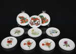 Dez(10) porta-copos em porcelana, remanescentes de conjuntos distintos, sendo sete exemplares com decoração floral policromada e três com representações de automóveis antigos identificados como Fiat 1899, Cadillac 1906 e Dion-Bouton 1903. Marcas de manufatura no verso. Medida: Diam.: 9 cm.