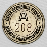 Colecionismo - Exonumia - Antiga Ficha da Caixa Econômica Federal - Antes dos sistemas de senha em papel, agências utilizavam fichas metálicas reutilizáveis para organizar a fila dos guichês. A letra indicava o tipo de serviço e o número a ordem de chegada.