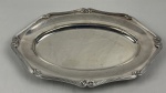 Fracalanza. Belíssima travessa oval em metal espessurado à prata, da afamada manufatura Fracalanza, modelo lacinho. Borda ricamente cinzelada. Medindo: 44 x 29 cm. Apresenta marcas de uso. 