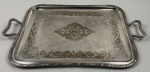 Wolff. Bandeja em metal espessurado à prata, ricamente cinzelada e lavrada com arabescos, volutas e rosas. Medindo: 50 x 32,5cm. 