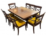LAUBISCH HIRTH. Importante conjunto de sala de jantar em madeira nobre composto por mesa retangular com tampo extensor, seis cadeiras e duas poltronas de cabeceira. Encostos vazados com desenho de influência neoclássica, ornamentados por aplicações em bronze. Mesa com base central sustentada por pés recortados, terminando em sabots de bronze e travessa decorada com aplicação. Assentos acompanhados por almofadas soltas. Tampo apresenta selo da manufatura Laubisch Hirth. Mesa: altura 72 cm largura 105 cm, comprimento aberto 250 cm e fechado 150. Cadeira 89 x 45 x 42 cm e poltrona; 93 x 53 x 47 cm. Apresenta marcas de uso, incluindo riscos no tampo.