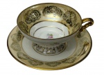 Mauá - Xícara de coleção para chá em porcelana nacional, esmaltada com ramalhetes florais policromados e rica ornamentação em douração sobre fundo marfim no efeito furta-cor, composta por arabescos, rendilhados e reservas geométricas. Manufatura no verso.