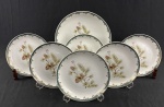 Steatita. Conjunto para sobrmesa em porcelana esmaltada e policromada, decorado com motivos florais e frisos em ouro. Composto de prato para bolo e 6 pratos para sobremesa. Manufatura no verso. Medindo: 27 cm e  19 cm.