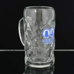 VIDRO, uma (1) caneca, grossa, incolor e translúcida, modelada em esferas, propaganda esmaltada da PAULANER MÜNCHEN, ideal para coleção de bar, capacidade 1 litro, medindo 20 cm altura, sinais de uso, vide foto.
