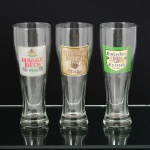 VIDRO, três (3) tulipas para cerveja, incolores e translúcidas, com propagandas distintas: DINKEL ACKER; EINBECKER e HAAKE BECK, marca MARTIN (H. Martin Glass Design, fundada no ano de 1898 em Manage, Bélgica, por Henry Martin; em 1939 passou a fabricar no Brasil com sede em Cotia, SP), medindo 23 cm altura, ideais para coleção de bar, vide foto.