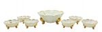 PORCELANA SÃO PEDRO, JUNDIAÍ - Conjunto com 01 bowl e 06 tigelas para sobremesa, com bordas onduladas decoradas com filetes dourados, e adornados internamente com coloridos motivos florais; base trípode em forma de volutas com douração. Em porcelana da manufatura brasileira São Pedro. Medidas: 21 x 9 cm; 11 x 5 cm. Douração com desgastes.