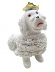 Bibelô com a representação e um cão poodle; corpo em porcelana com pelos e boina colorida em biscuit. Medidas: 12 x 11 cm. Boina com ínfimo dano; com ínfimas manchas no biscuit.