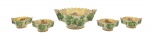 WEISS - Conjunto para sobremesa composto por 01 bowl maior e 04 bowls menores, com bordas onduladas e duas pegas laterais, decorados à mão com douração salpicada na parte interna, e motivos florais e vegetalistas em tons de verde na parte externa; em cerâmica esmaltada. Medidas: 29 x 10 cm; 16 x 5 cm. Bowl maior com ínfimo bicado na borda; um dos bowls menores com ínfimo bicado em uma das pegas laterais; um dos bowls com ínfimo fio de cabelo em uma das pelas laterais.
