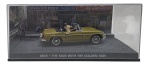 ALTAYA - 007 JAMES BOND CARS COLLECTION - MGB - THE MAN WITH THE GOLDEN GUN - Miniatura do carro  do icônico personagem James Bond, o espião 007, MGB do filme 007 O Homem da Pistola de Ouro, em escala 1:43, feito em metal com partes plásticas, protegido em uma caixa expositora de acrílico com cenário embutido. Ano: 2008.