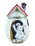 PORCELANA, uma (1) biscoiteira confeccionada em porcelana na tonalidade branca no feitio de ovo, representando casa de coelho em relevo, pintura furtacor na tonalidade verde, realces em ouro e teto vermelho, medindo 17,5x8,5cm.