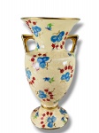 FAIANÇA, um (1) vaso ânfora confeccionado em faiança vitrificada na tonalidade creme, decorado por flores e folhagens em policromia com realces filetados em ouro, apresenta craquele, marcas do tempo e bicado na base, medindo 27x14cm.