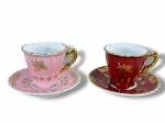 PORCELANA SCHMIDT, duas (2) xícaras para café de coleção com seus respectivos pires confeccionados em porcelana na tonalidade branca com pintura na tonalidade rosa e vermelha, decorada por elementos florais e vegetalistas filetados em ouro, medindo 5x6,5x5cm.