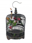 DIVERSOS, uma (1) gaiola ornamental em madeira pintada na cor preta, formato arredondado, com gancho superior para pendurar, base decorada e aplicação interna com galhos, folhas, frutos artificiais e pássaro em madeira pintada, medindo 40x25cm.