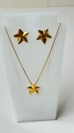 SEMI JÓIAS - Conjunto de semi joias banhadas a ouro composto por colar com pingente e par de brincos de estrela. Design fino e elegante, com brilho intenso e acabamento polido.