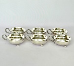 Conj. com 6 (seis) Taças baixas para sorvete em metal espessurado à prata, alças decoradas com folhas e pés em bola, med. 8,5cm de diâmetro. Apresenta desgaste.