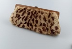 Bolsa em courino , revestido com pelinhos em animal print . Apresenta marcas do tempo . Medindo : 25x12 cm.