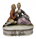 Caixa porta joias em biscuit, com escultura  representando. Medindo: 16,5 x 11 x 15 cm.