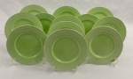 GRINDLEY, Inglaterra. Doze pratos de sobremesa em faiança inglesa na cor verde, de desenho característico Art Déco, com decoração concêntrica em relevo. Manufatura no verso. Med.: 18 cm diâm. 3 com avarias.