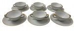 Renner - Seis consumes em porcelana com seus respectivos pires na cor branca esmaltado com filete dourado.