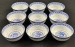 China. Nove bowls em porcelana chinesa, com decoração em policromia azul sobre fundo branco, apresentando motivo central de dragão e borda ornamentada com frisos geométricos em estilo oriental. Padrão Grão de Arroz. Medindo: 5 x 10 cm.