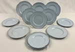 Greydawn Johnson Brother,  England. Conjunto com seis pratos de sobremesa e seis para pão  em faiança, linha Greydawn, produzidos na Inglaterra, em elegante tonalidade azul-claro /característica da linha Utility Ware, de inspiração colonial, com bordas suavemente recortadas e delicado friso prateado contornando toda a aba, datado entre as décadas de 1940 e 1970, com marca de manufatura no verso. Medindo; 18 cm e 16 cm, 2 com manchas.