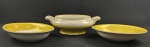 Mauá. Duas saladeiras e sopeira sem tampa em porcelana esmaltada com borda amarela sobre fundo banco. Filetes em ouro. Manufatura no verso. Medindo: 5 x 23 cm, 5 x 27 x 20 cm e 10 x 29 x 23 cm.