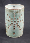Floreira em cerâmica com esmalte verde, corpo cilíndrico vazado por perfurações circulares, acabamento com frisos horizontais na base e no bocal. Medindo: 17,5 x 10,5 cm.
