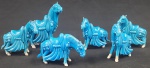 Seis figuras decorativas em porcelana esmaltada representando cavalos estilizados em tom azul, com detalhes em relevo.  altura do maior 10 cm, apresentando bicados.