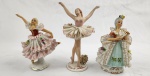 Três esculturas em porcelana esmaltada e policromada, representando dançarinas e dama Medindo: 11x8 cm 12 x 7 cm e 13 x 10 avarias na saia e 1 com braços colado.