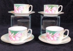 GERMANY RS - Quatro xicaras e seus respectivos pires em porcelana Alemã branca com pintura verde e policromia floral de orquidea. Atenção: Apresenta fio de cabelo, há registro do fio de cabelo nas fotos.