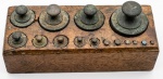 Base em madeira, quinze(15) pesos para balança , acoplados em suporte de madeira. MED : 11 X 10 X 26