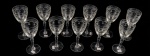 Conjunto com 11 taças de água em cristal europeu com lapidação em baixo relevo, decoração floral interligadas por arcos, frisos e serrilhados ao gosto Saint-Louis. 19x8 cm 8cm.
