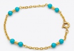 Pulseira de ouro 18k com contas esféricas de turquesa intercaladas.17 cm. Peso total bruto: 2.33g.