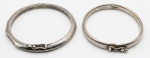 Duas pulseiras rígidas em prata de lei, uma delas com contas brilhantes e marcassitas. Peso total bruto: 25.6.