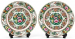 Par de pratos decorativos ( Rose Medallion ) em porcelana chinesa com pintura esmaltada em rica policromia. Pintura esmaltada com flores, folhagens, aves, borboletas, frutas e símbolos de longevidade. Assinado no verso. Medidas 26cm