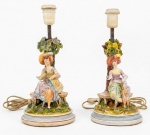 Par de luminárias em porcelana europeia com rica policromia representando damas antigas. Apresentam, falhas... vendidas no estado. 20 cm. e 29 cm com o bocal.