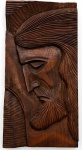Placa de madeira entalhada representado "Face de Cristo". 57 x 25 cm.