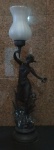 Geo Maxim (1920) - Luminária Francesa de petit bronze patinado, representando figura feminina segurando coroa de louros simbolo da vitória e uma tocha. Manga de vidro branco satinado. Altura total 90 cm.  Assinada e funcionando.