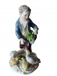Figura em porcelana de Meissen, menino alimentando gansos, criada por Johann Joachim Kaendler por volta de 1769. Marca de espadas azuis cruzadas e numerada C41, século XIX. Reproduzida no catálogo de Meissen - Bergmann. Medida: 12,5cm