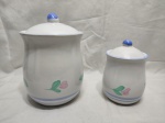 Jogo de 2 potiches porcelana com pintura de flores. Medindo o maior 14,5cm x 17cm de altura.