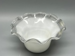 Cúpula antiga em demi cristal opalinado, formato tulipa com bojo liso e arredondado. Apresenta abertura superior com aba expandida, finalizada com delicada borda ondulada em acabamento incolor. Medidas: 8x5,5x15 cm. Apresenta marcas do tempo, de uso e bicados.