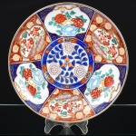 PORCELANA JAPONESA, um (1) prato decorativo, pintado a mão em policromia no padrão IMARI com elementos vegetalistas e geométricos, arremates a ouro, verso com marca de origem, made in japan, medindo 24 cm diâmetro, vide foto.