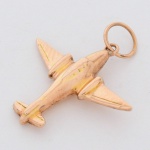 BIJUTERIA, um (1) pingente representando avião, confeccionado em metal dourado, medindo 2 cm, vide foto.