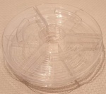 Petisqueira em acrílico transparente com três divisórias com tampa medindo 43x10 cm.