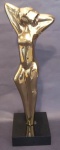 Escultura de mulher em metal dourado com suporte em madeira laqueada preta medindo 28x8 cm.
