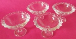 Quatro taças de sobremesa Wolf linha Pearl feita de cristal e possui bordas com pequenas esferas medindo 7x5x6x4 cm.