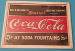 Quadro Coca-cola moldura cor de madeira medindo 32x43 cm.